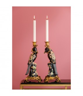 A pair of porcelain candlesticks splendid blue and pink parrots resting on a branch of trees